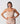 Woman wearing a beige tank top and leggings against a white background